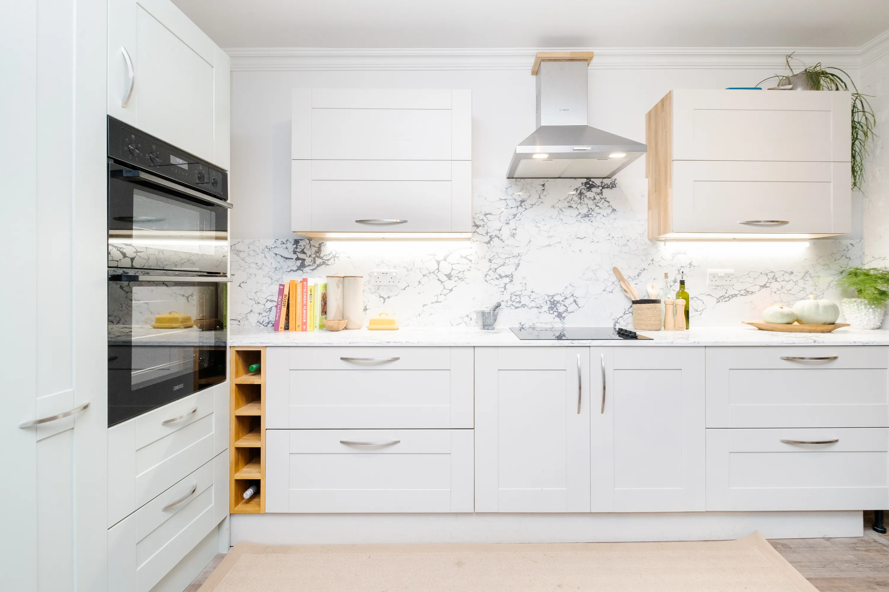 Photo of bathroom with marble walls and gold tap
