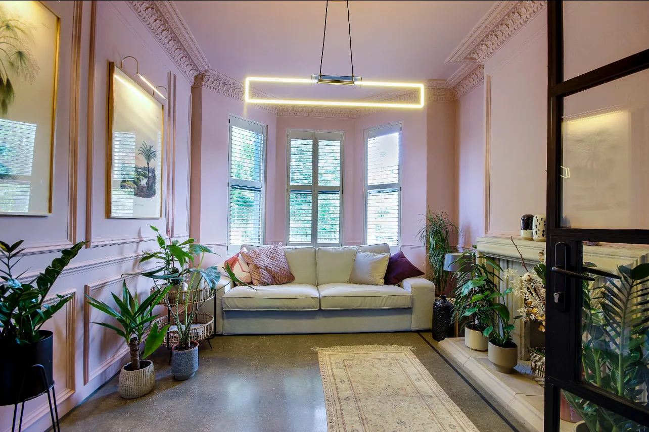 Photo of bathroom with marble walls and gold tap