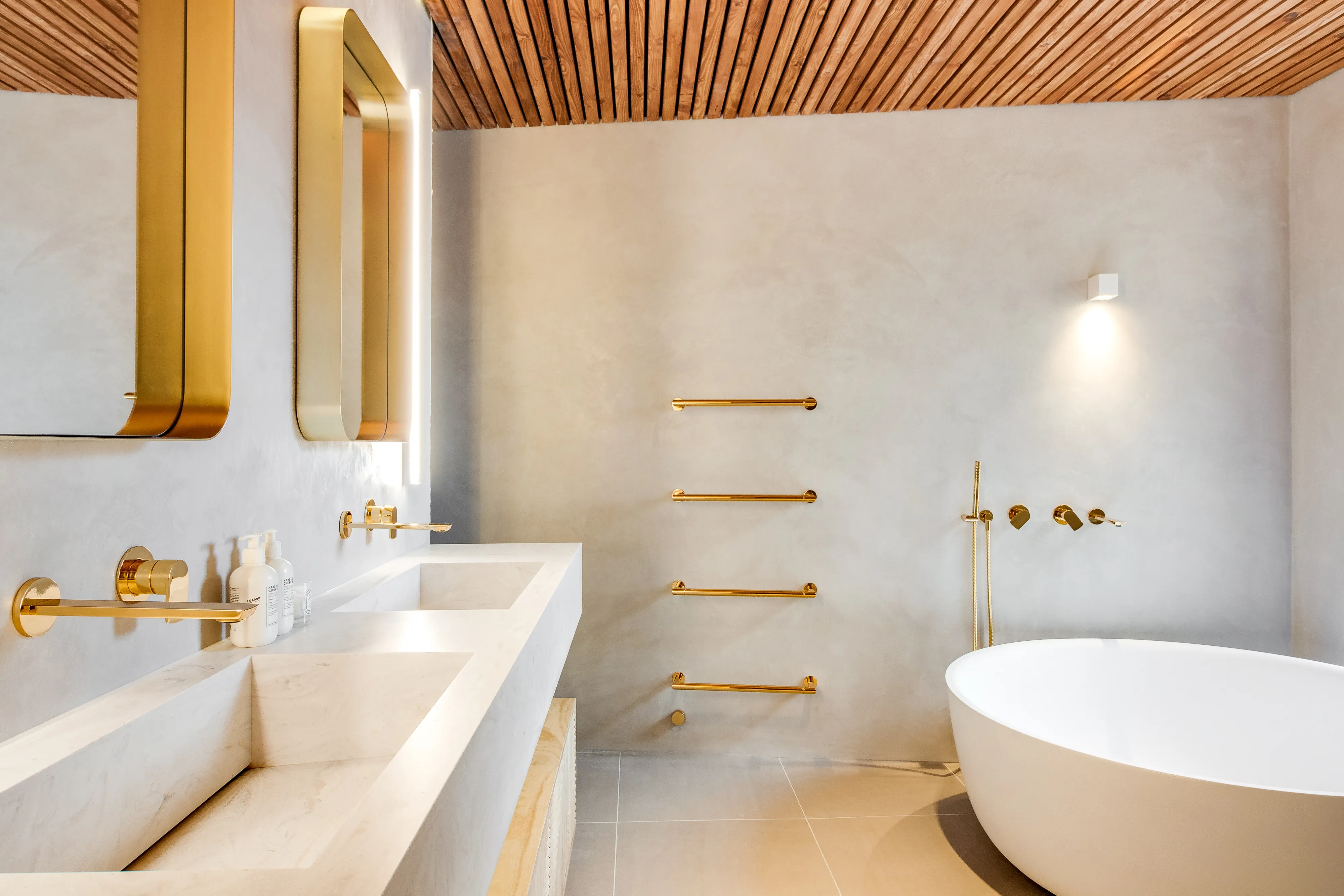 Photo of kitchen with marble worktop and gold tap