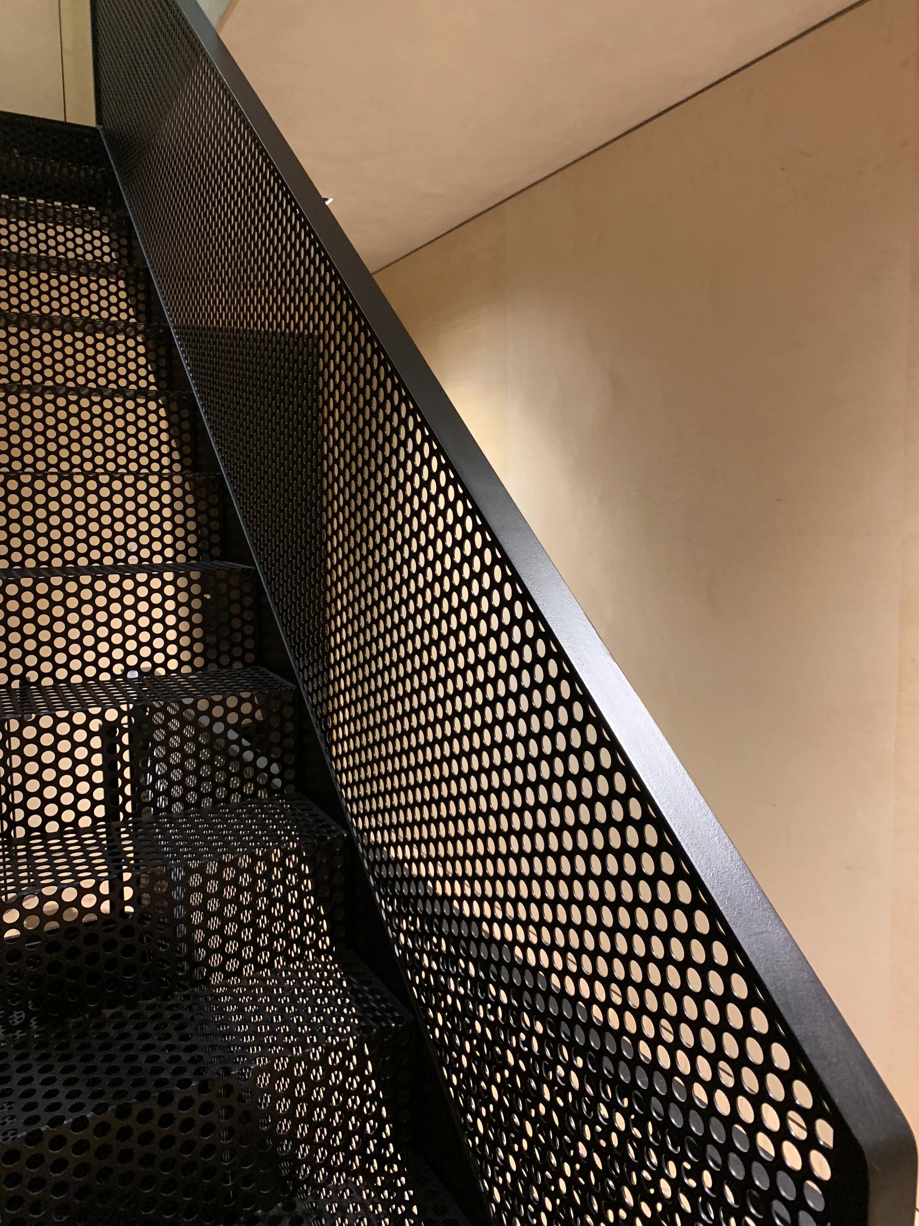 Photo of bathroom with marble walls and gold tap