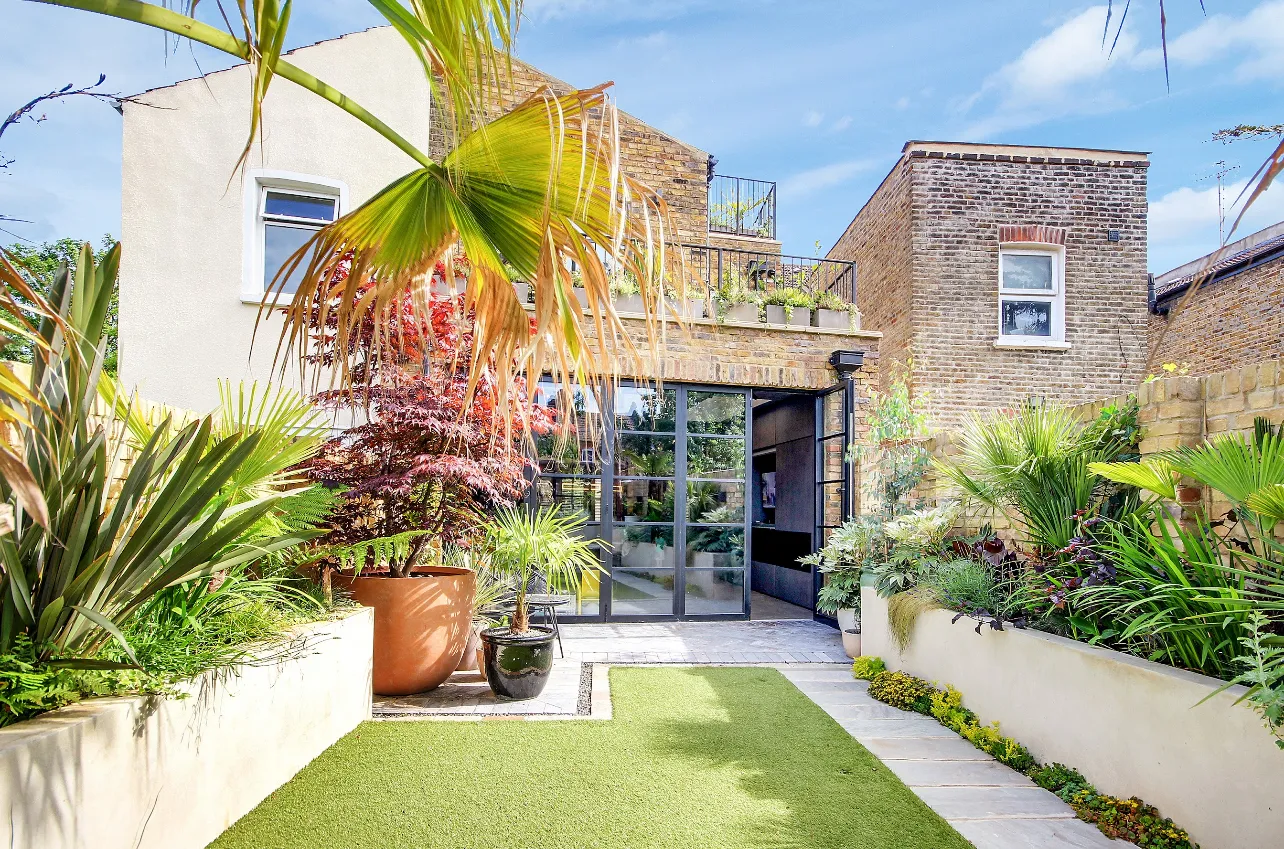 Photo of bathroom with marble walls and gold tap