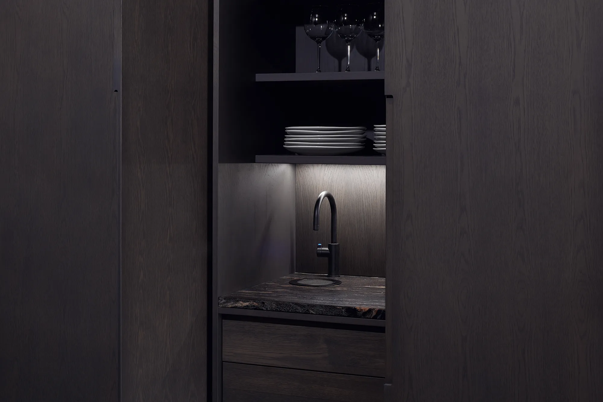 Photo of bathroom with marble walls and gold tap
