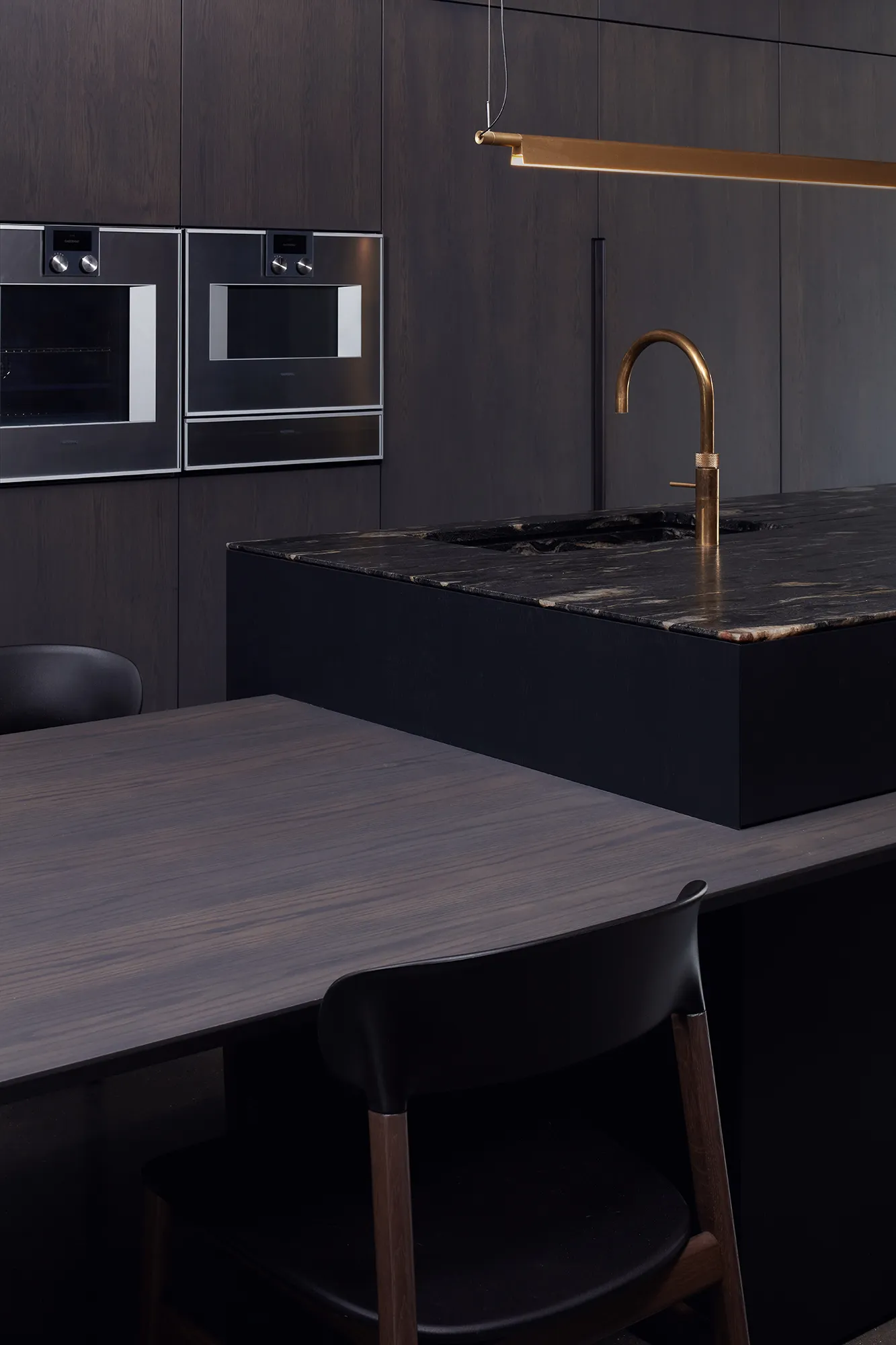 Photo of bathroom with marble walls and gold tap