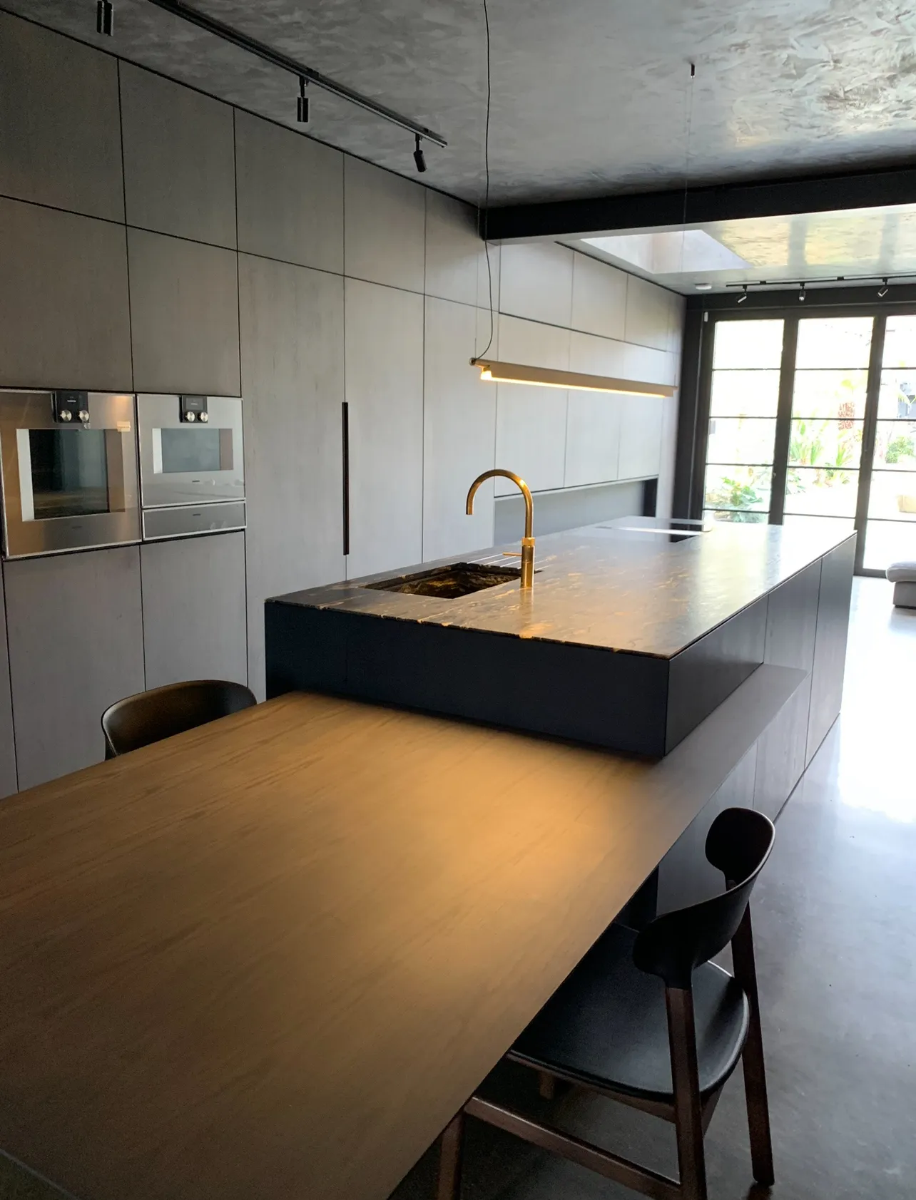 Photo of bathroom with marble walls and gold tap