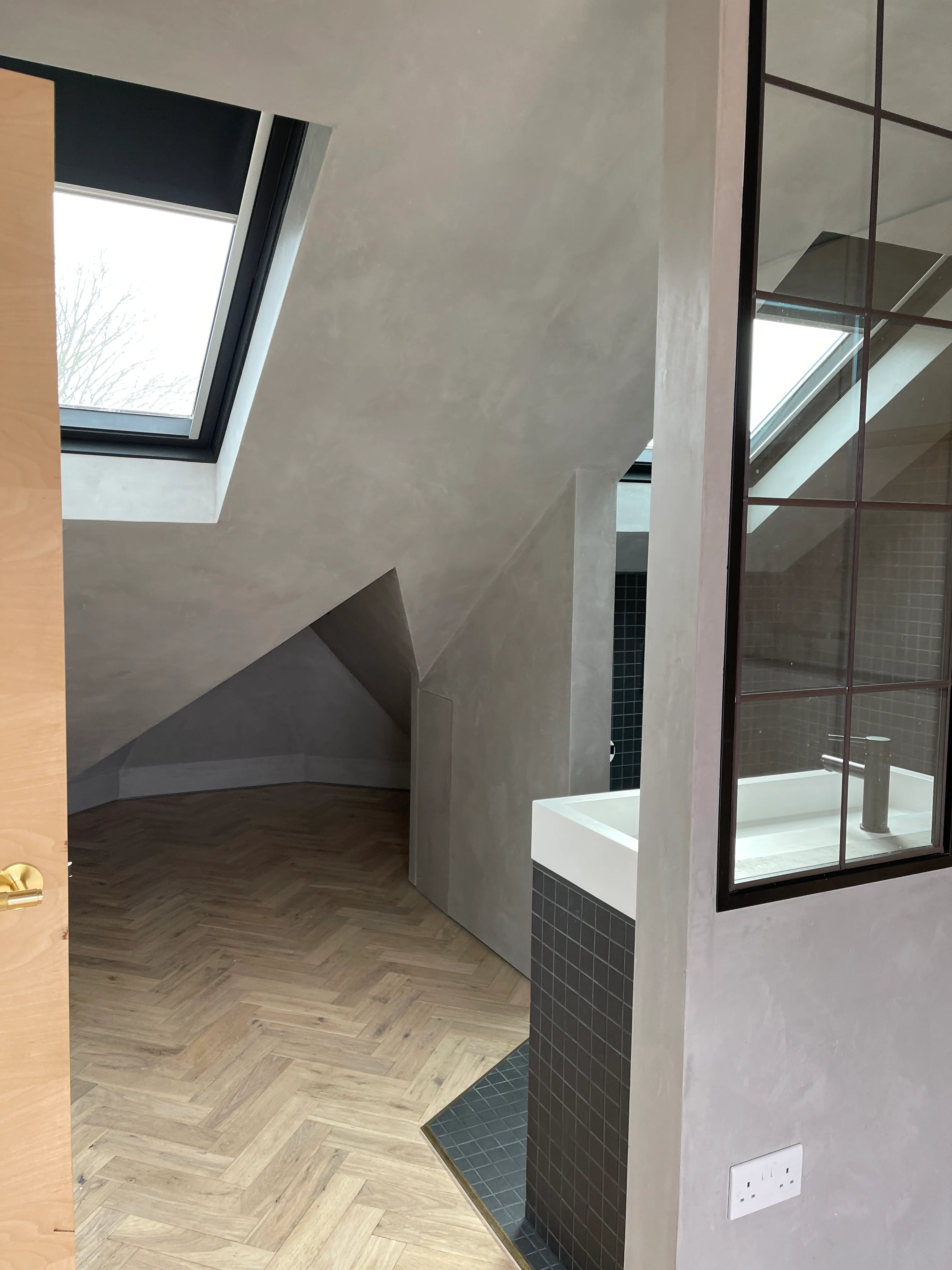 Photo of bathroom with marble walls and gold tap