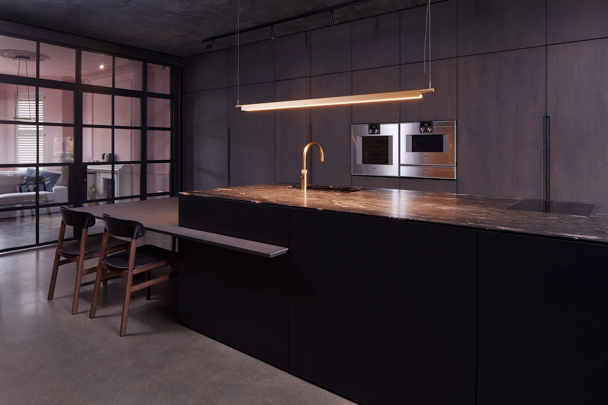 Photo of bathroom with marble walls and gold tap