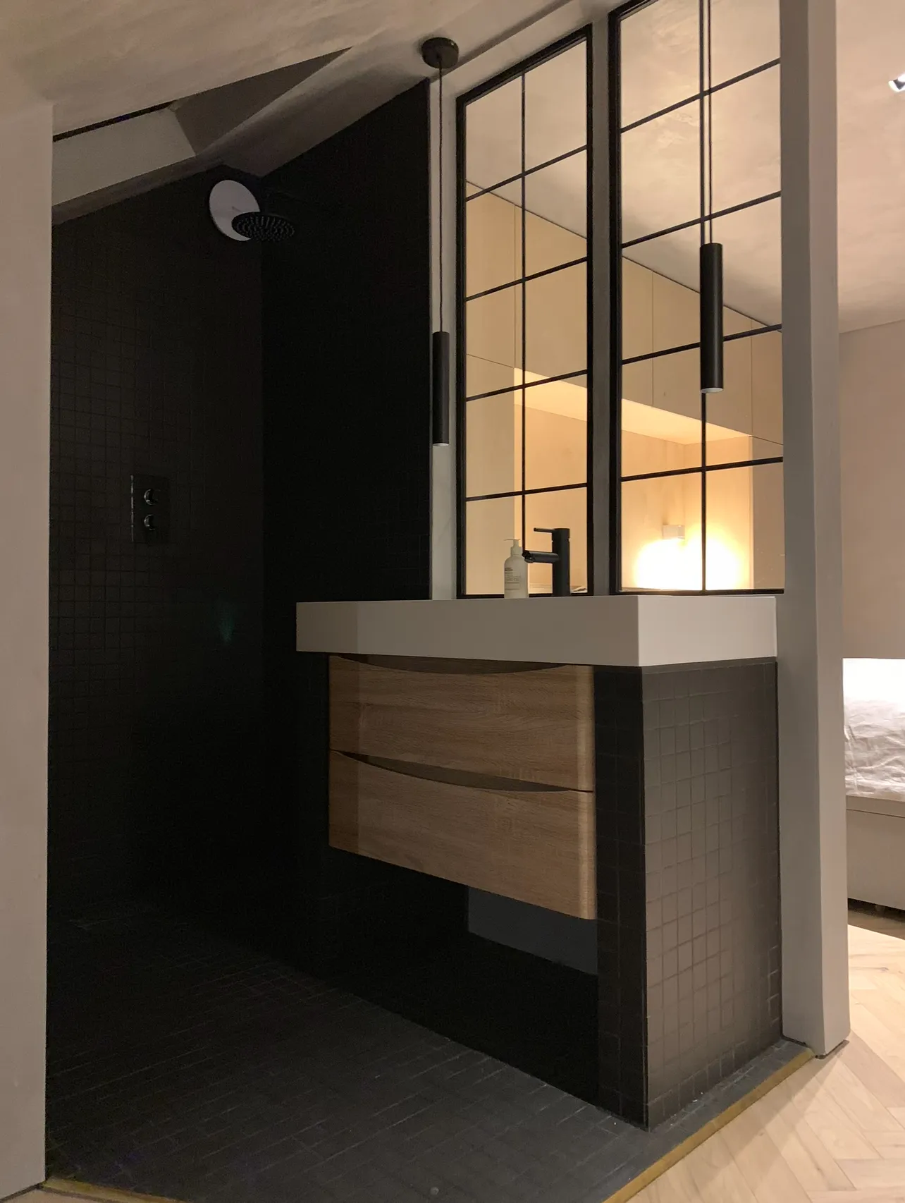 Photo of bathroom with marble walls and gold tap